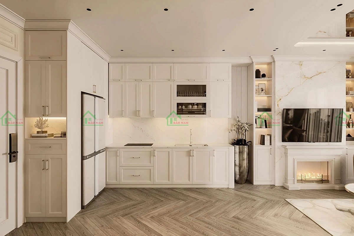 Tủ bếp gỗ phong cách tân cổ điển với viền pano tinh tế, hệ thống ngăn kéo hiện đại, tối ưu không gian lưu trữ.