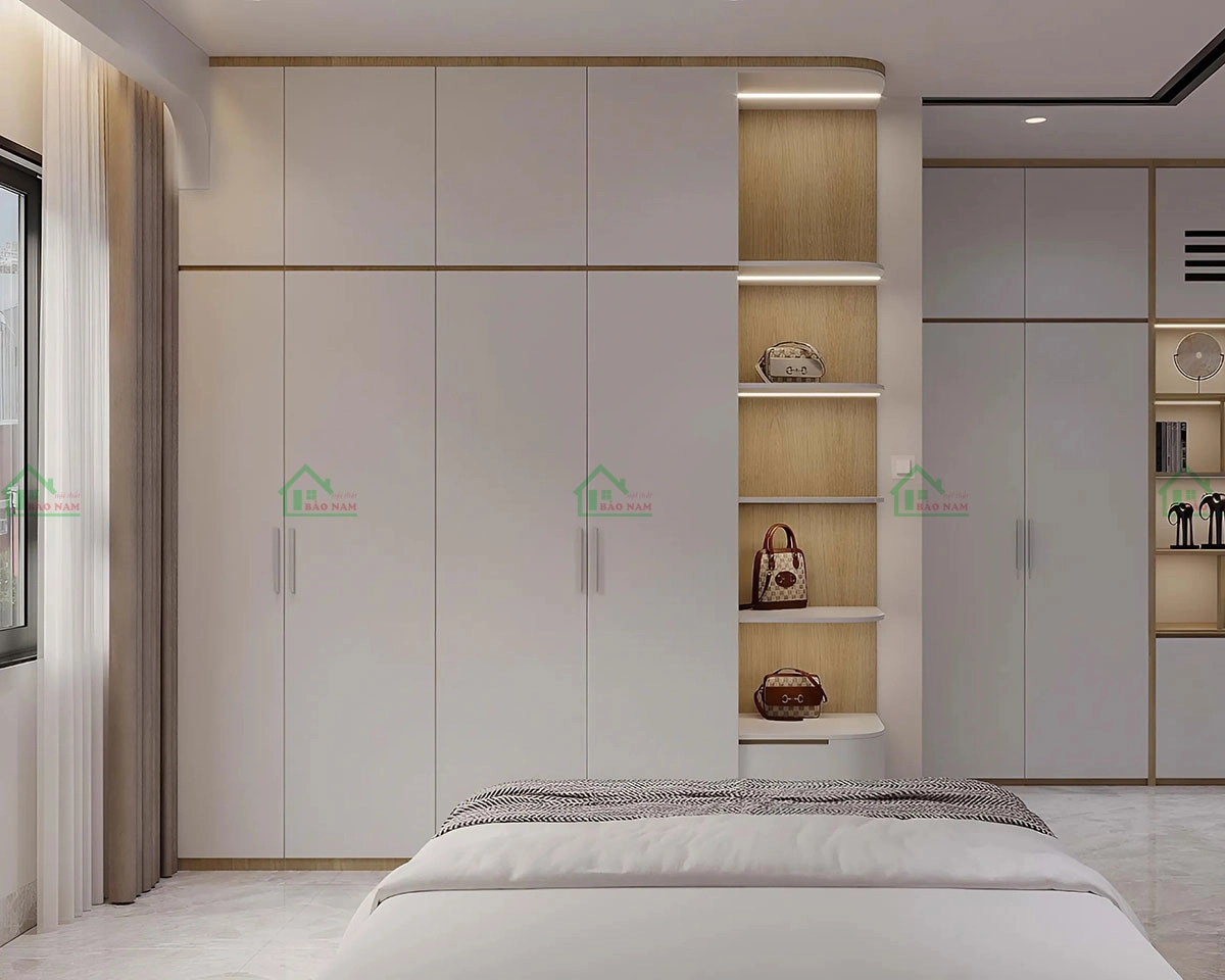 Tủ quần áo hiện đại, màu trắng chủ đạo, kết hợp với kệ màu vân gỗ tự nhiên, mang lại sự ấm áp và tinh tế cho không gian phòng ngủ.